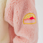 Détail de la veste en peluche rose avec blocs de couleur, enfant