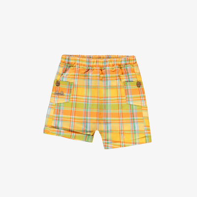 Short orange, vert et jaune à carreaux, naissance