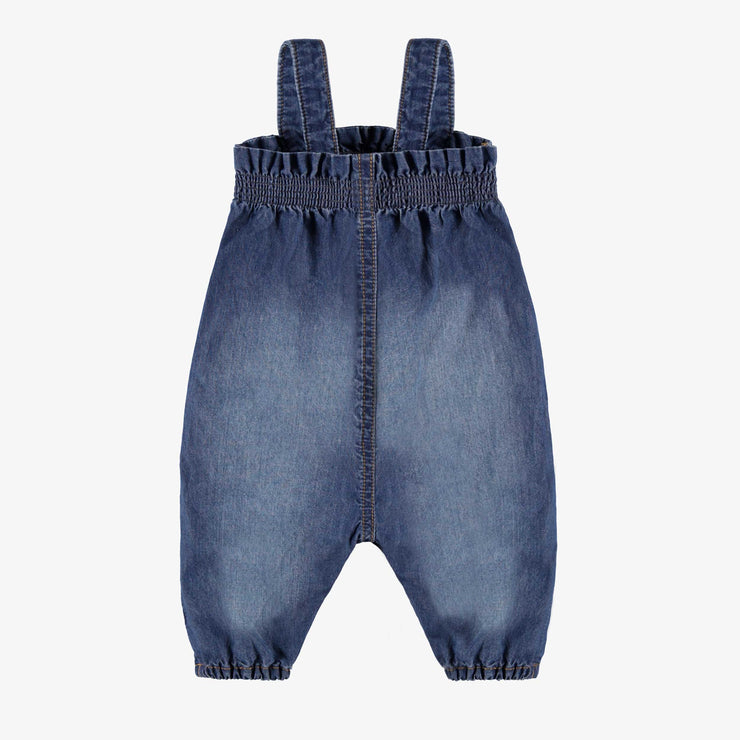 Dos de la salopette en denim bleu moyen au look usé, naissance