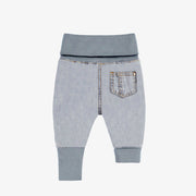 Dos du pantalon évolutif en denim bleu pâle, naissance
